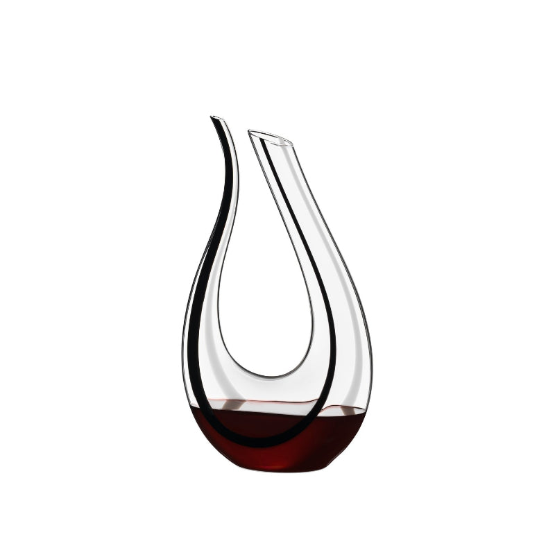 Glass wine decanter with teardrop shape and clear body, dark amber tint at base