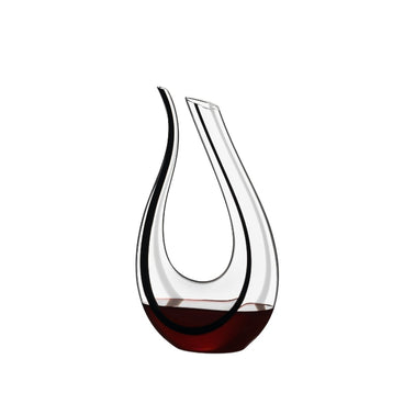 Glass wine decanter with teardrop shape and clear body, dark amber tint at base