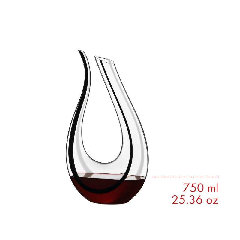 Teardrop glass wine decanter with clear upper and dark red-amber base, side view