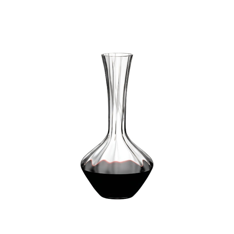 Glass wine decanter with narrow neck and dark red liquid, clear crystal finish